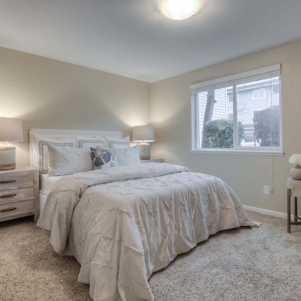 Bedroom with large windows at Spinnaker Apartments in Des Moines, Washington