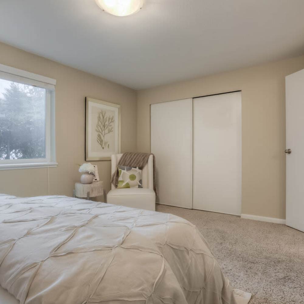 Bedroom with plush carpeting at Spinnaker Apartments in Des Moines, Washington