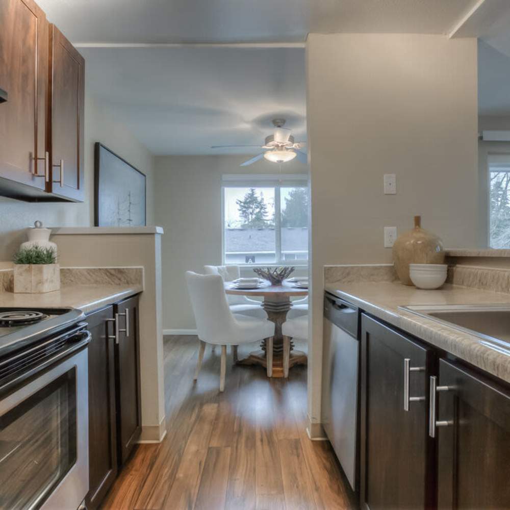 Kitchen with wood-style flooring at Spinnaker Apartments in Des Moines, Washington
