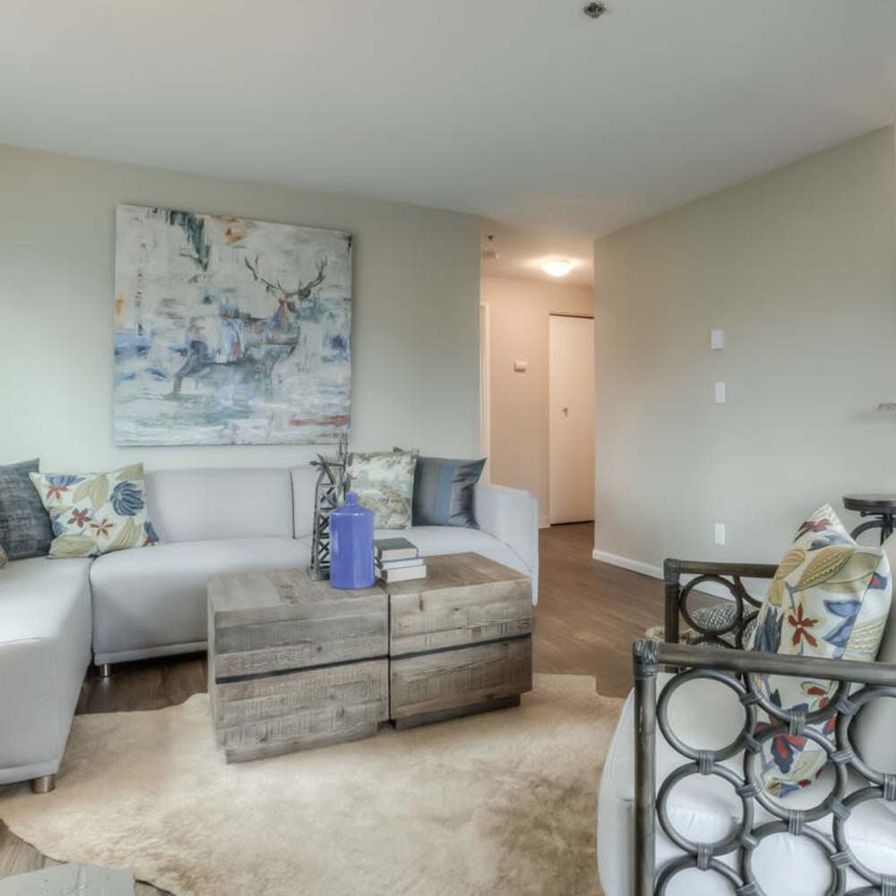 Living space with a couch and foot rest at Spinnaker Apartments in Des Moines, Washington