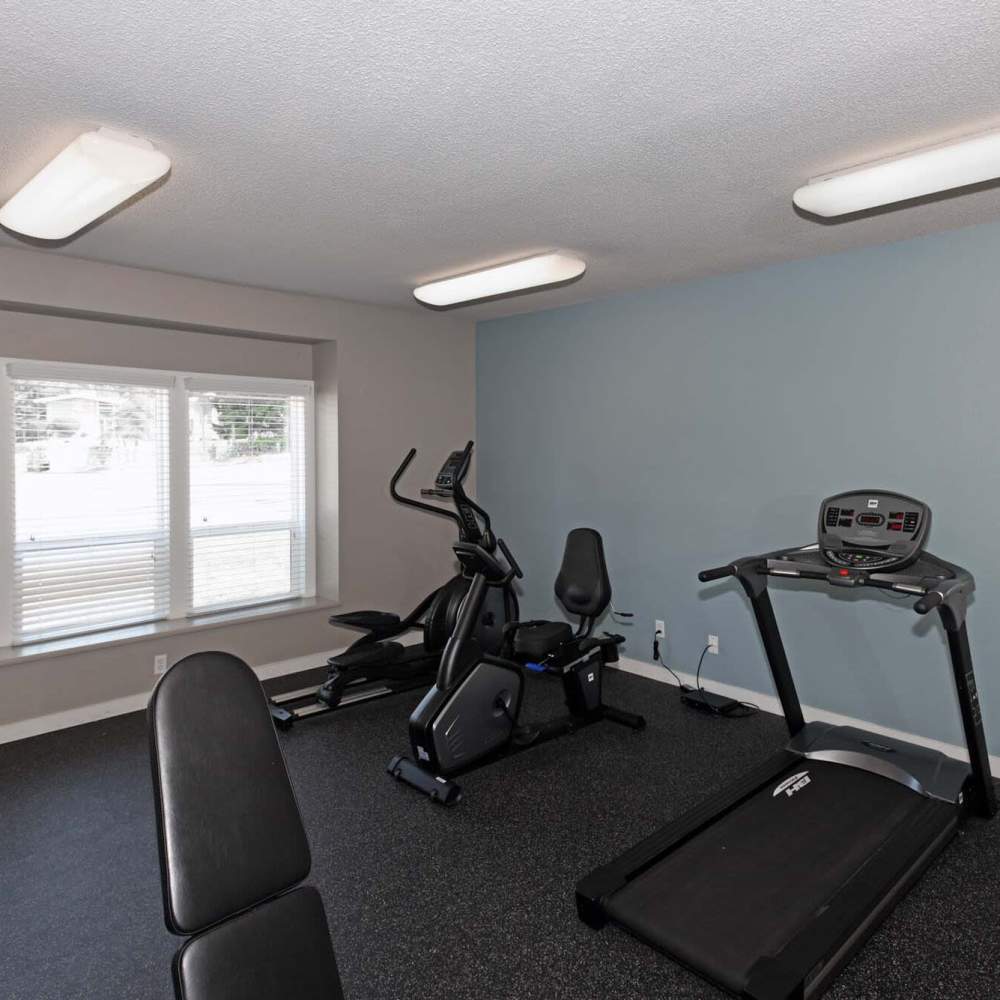 Fitness center with a treadmill at Spinnaker Apartments in Des Moines, Washington