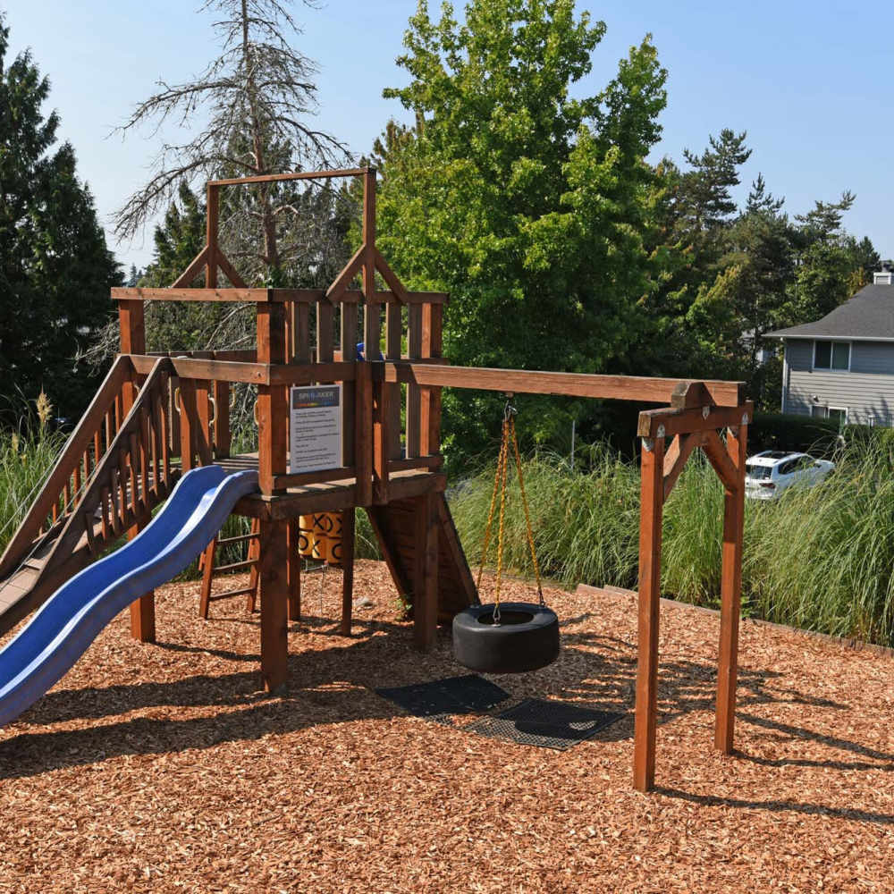 Playground with bark dust at Spinnaker Apartments in Des Moines, Washington