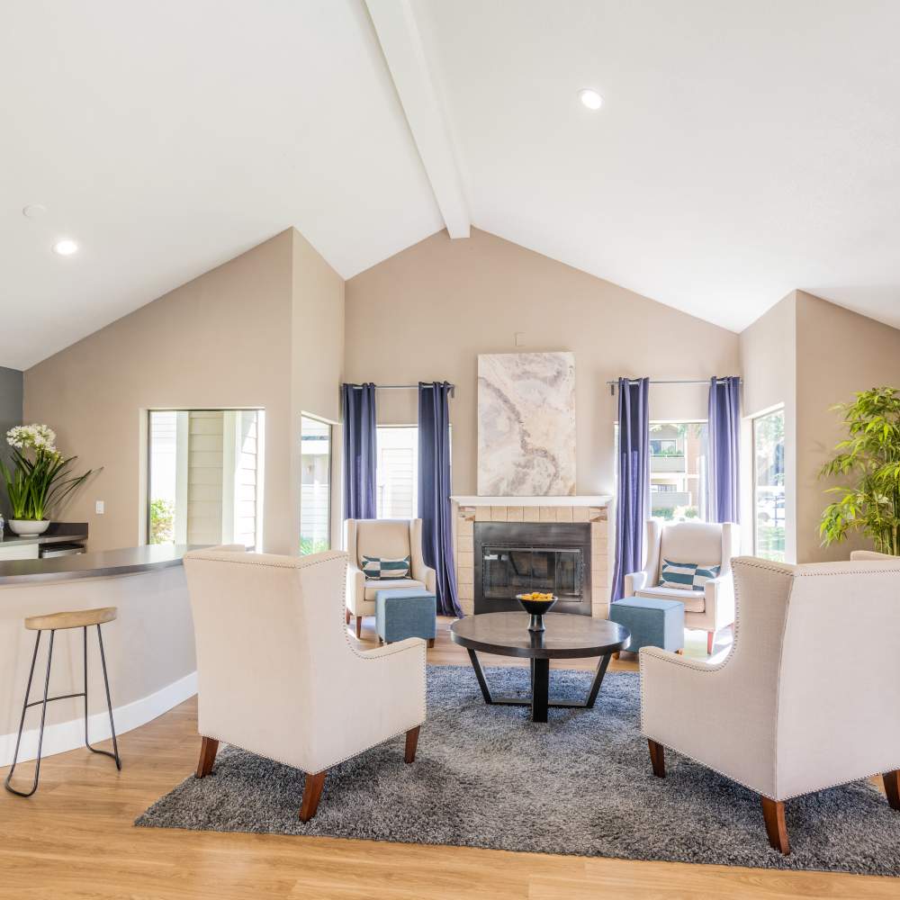 Bar area with pleasing chairs and tables perfect for waiting and small gatherings in Riverstone Apartments in Sacramento, California