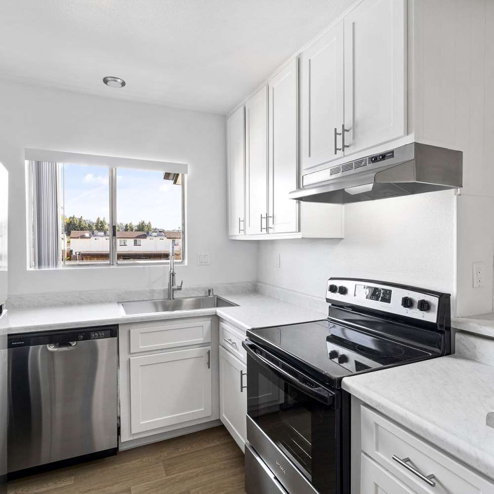 Kitchen with a dishwasher at Terre at Mollison in El Cajon, California