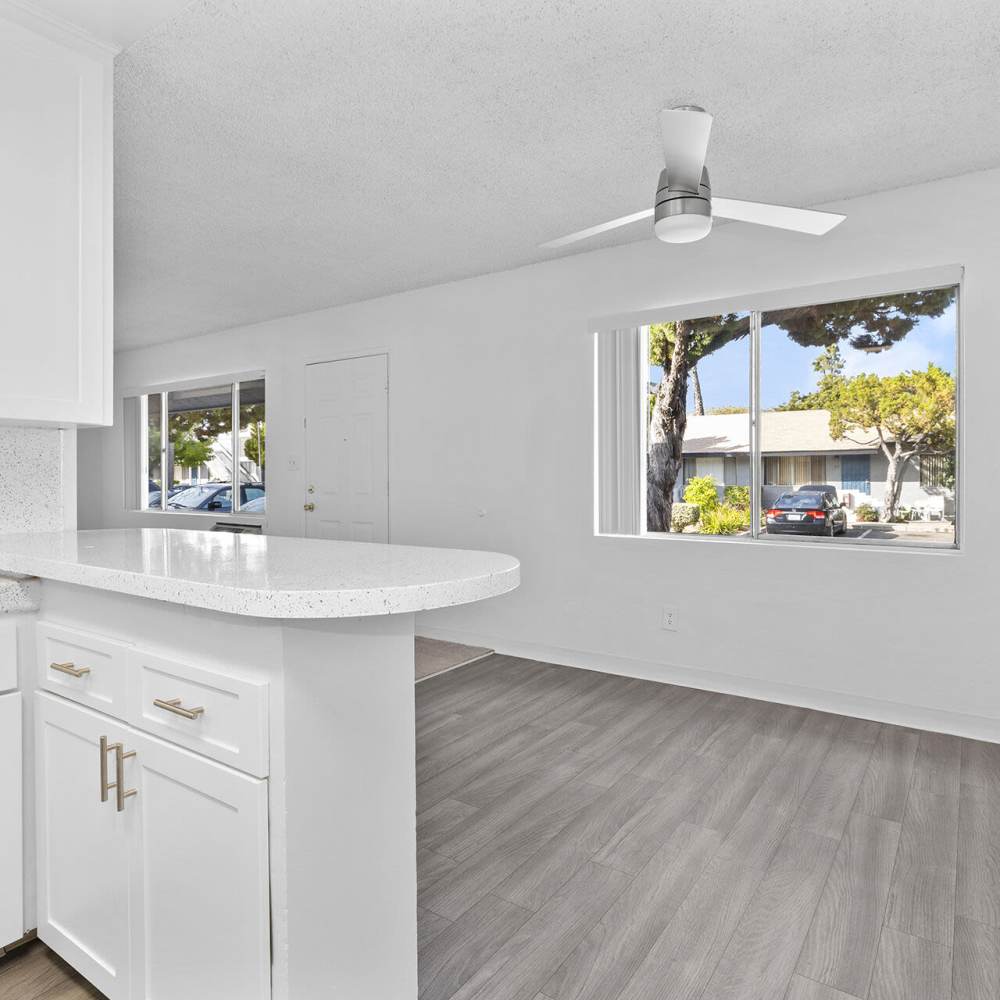 Kitchen and dinning space with wood-style flooring at Terre at Mollison in El Cajon, California