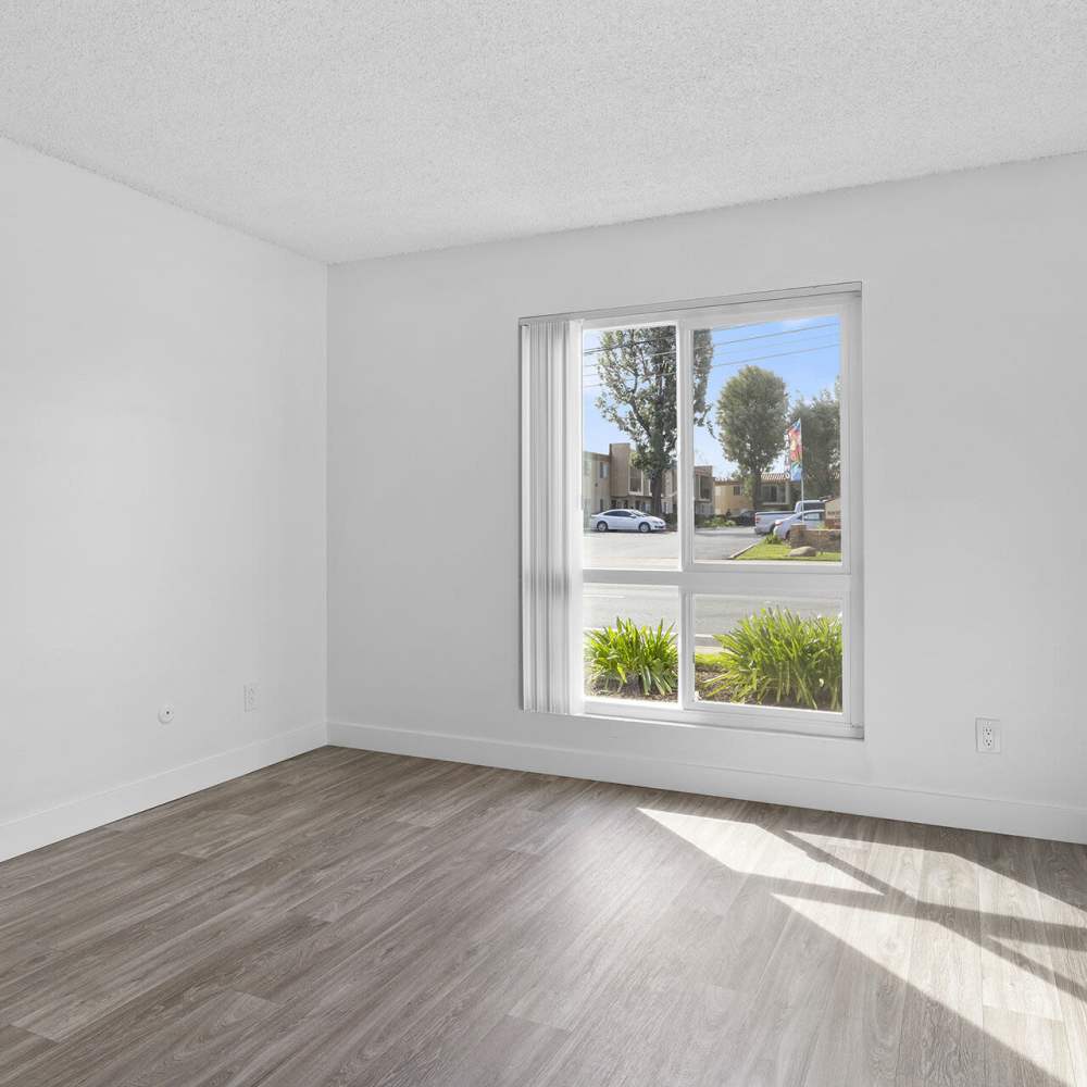 Bedroom with large windows at Terre at Mollison in El Cajon, California