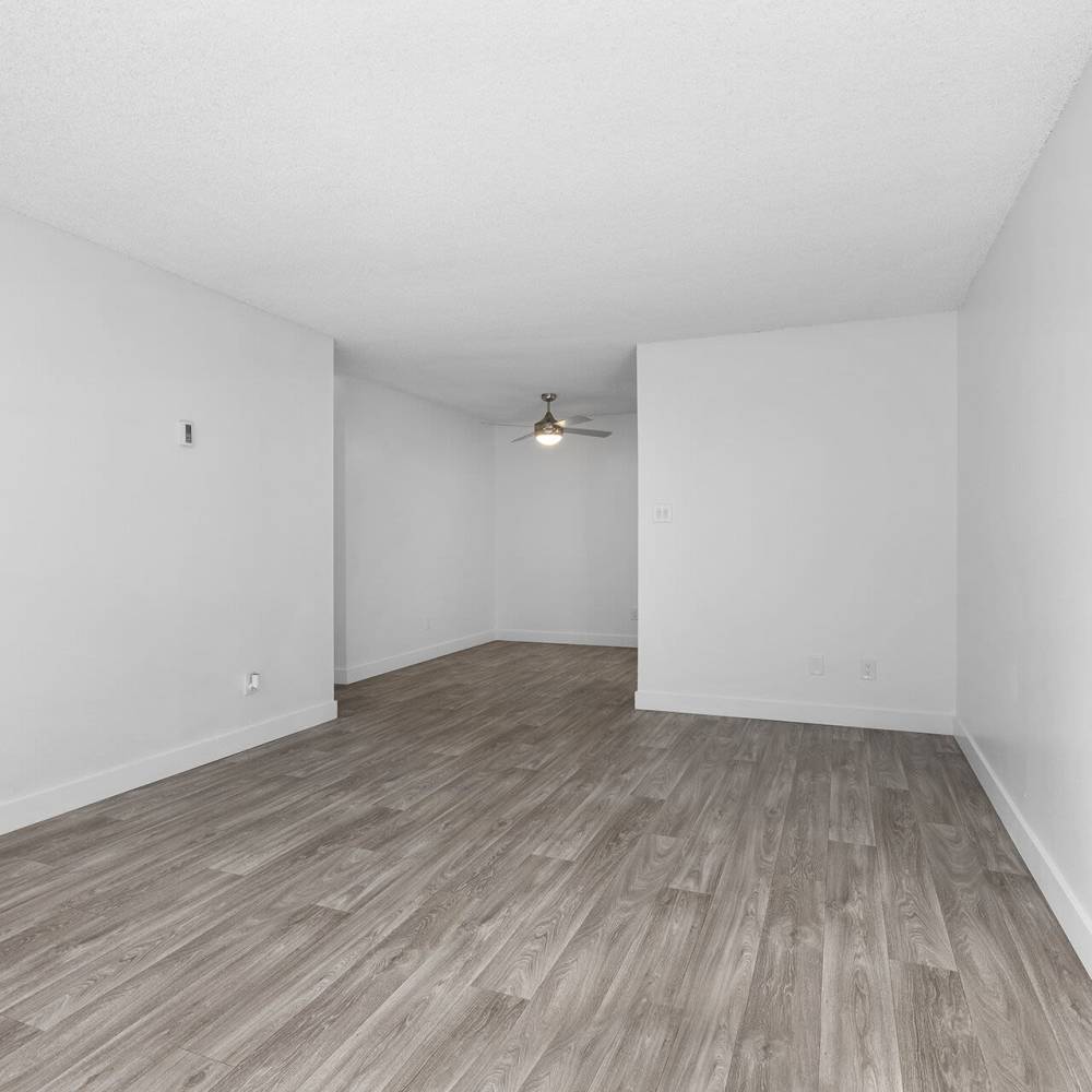 Living space with wood-style flooring at Terre at Mollison in El Cajon, California