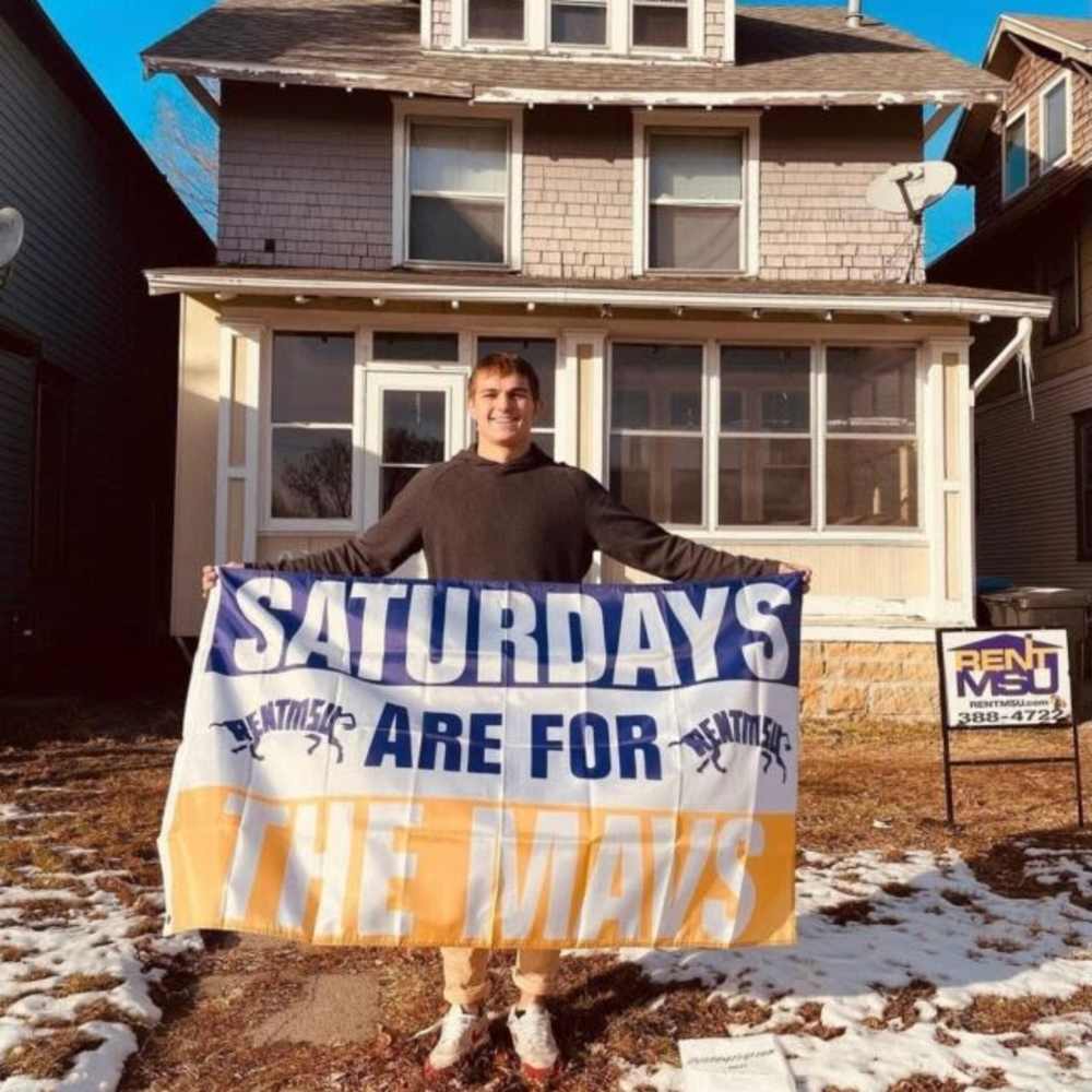 Resident with school spirit flag at RentMSU in Mankato, Minnesota