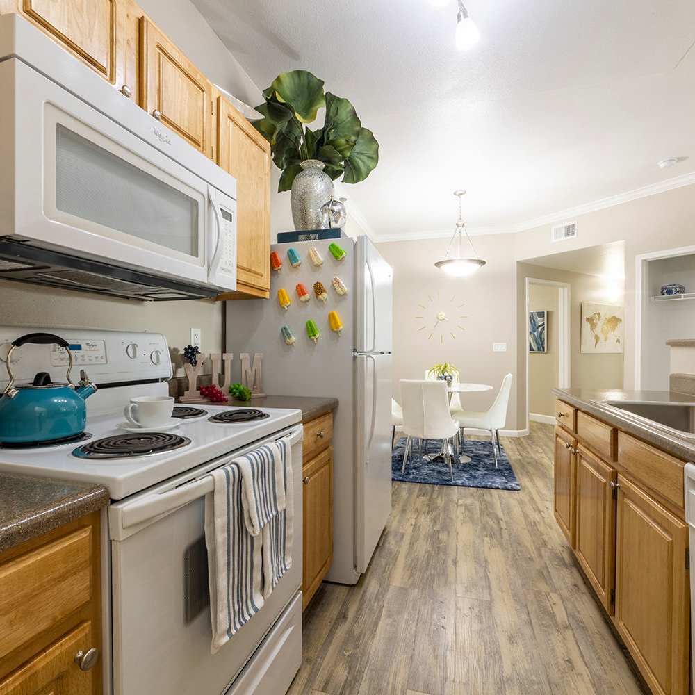 Kitchen in an apartment with wood-style flooring at Canyon Vista in Sparks, Nevada