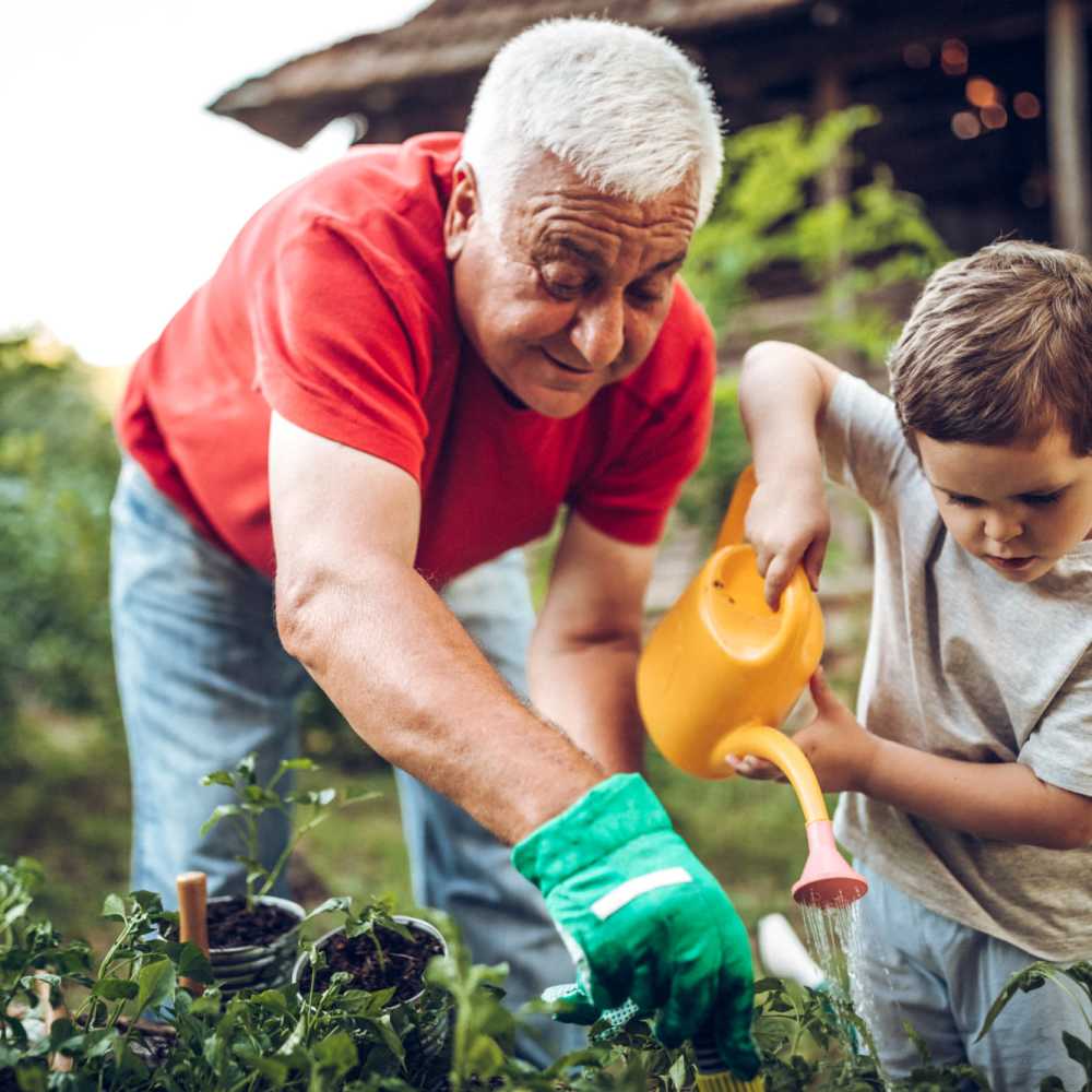 Resident gardening with his grandson Revela at Mt. Pleasant Independent Living in Mt Pleasant, South Carolina