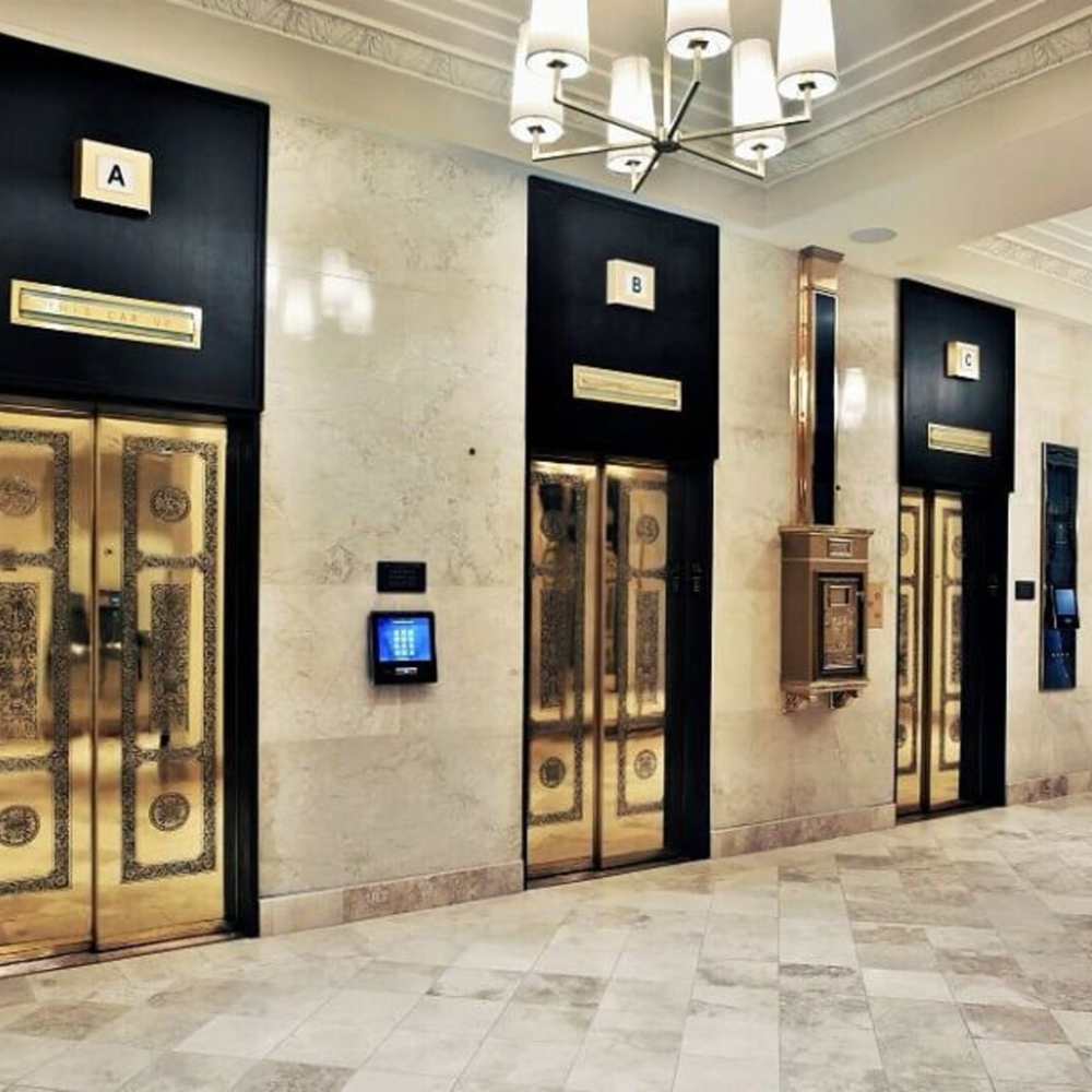 Golden elevator with closed doors in hallway at The Residences at Barnett in Jacksonville, Florida