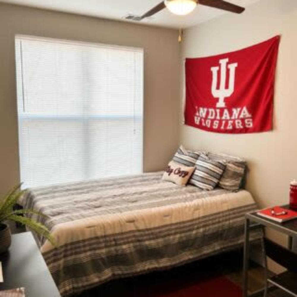 Bedroom with Indiana flag at The Quarters at Bloomington in Bloomington, Indiana