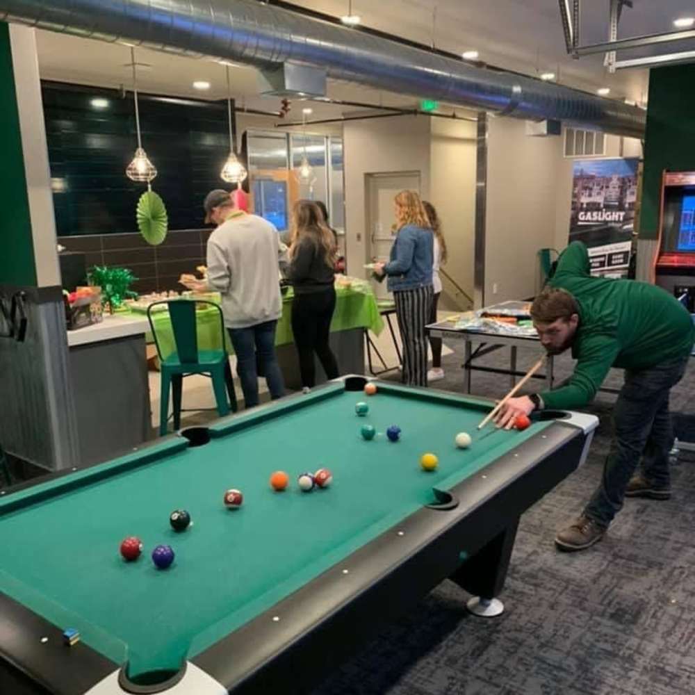 Residents playing pool at The Quarters at East Lansing in East Lansing, Michigan