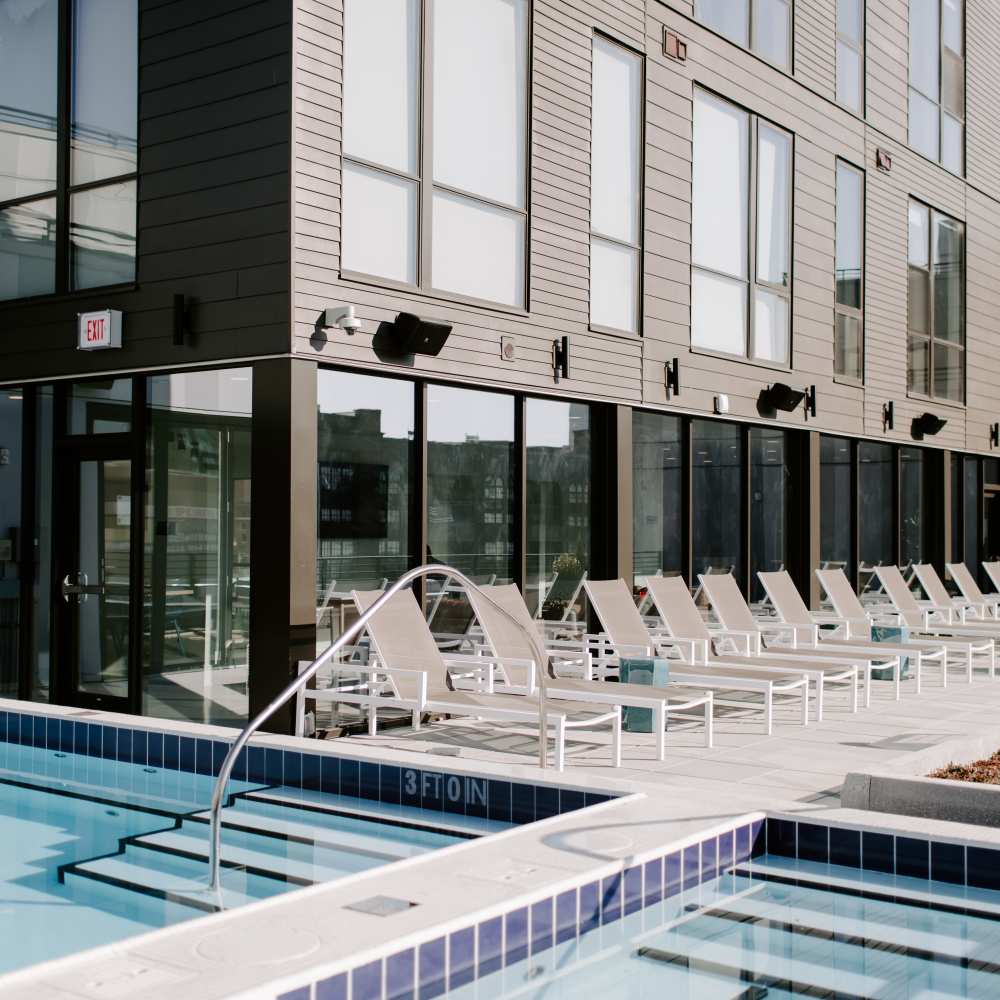 Rooftop poolside lounge chairs at Industry Columbus Apartments in Columbus, Ohio