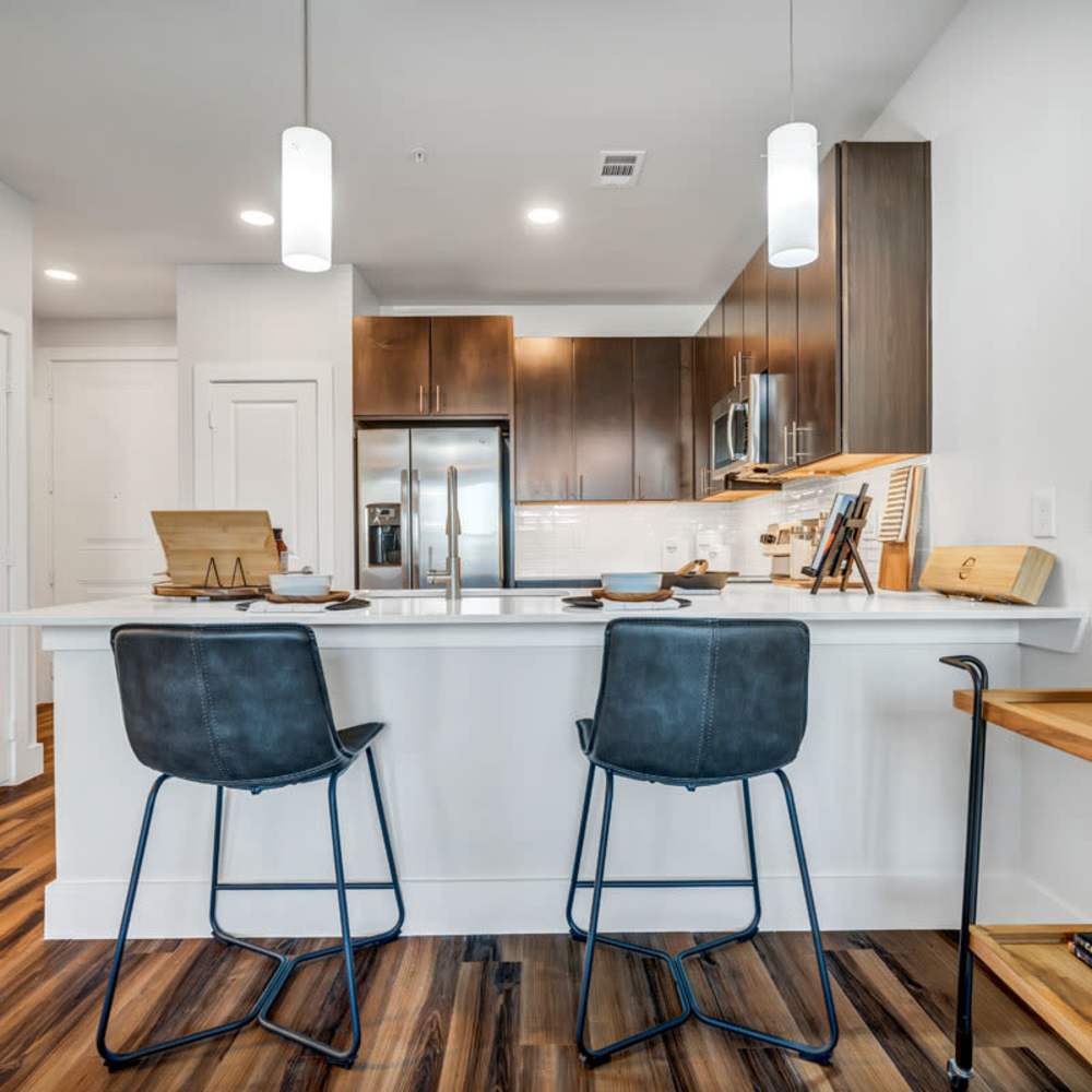 Kitchen island with stools at Chisholm at Tavolo Park in Fort Worth, Texas
