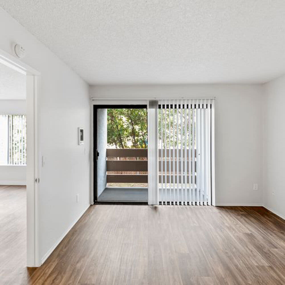 Living space with wood-style flooring at Mar at Mesa in San Diego, California