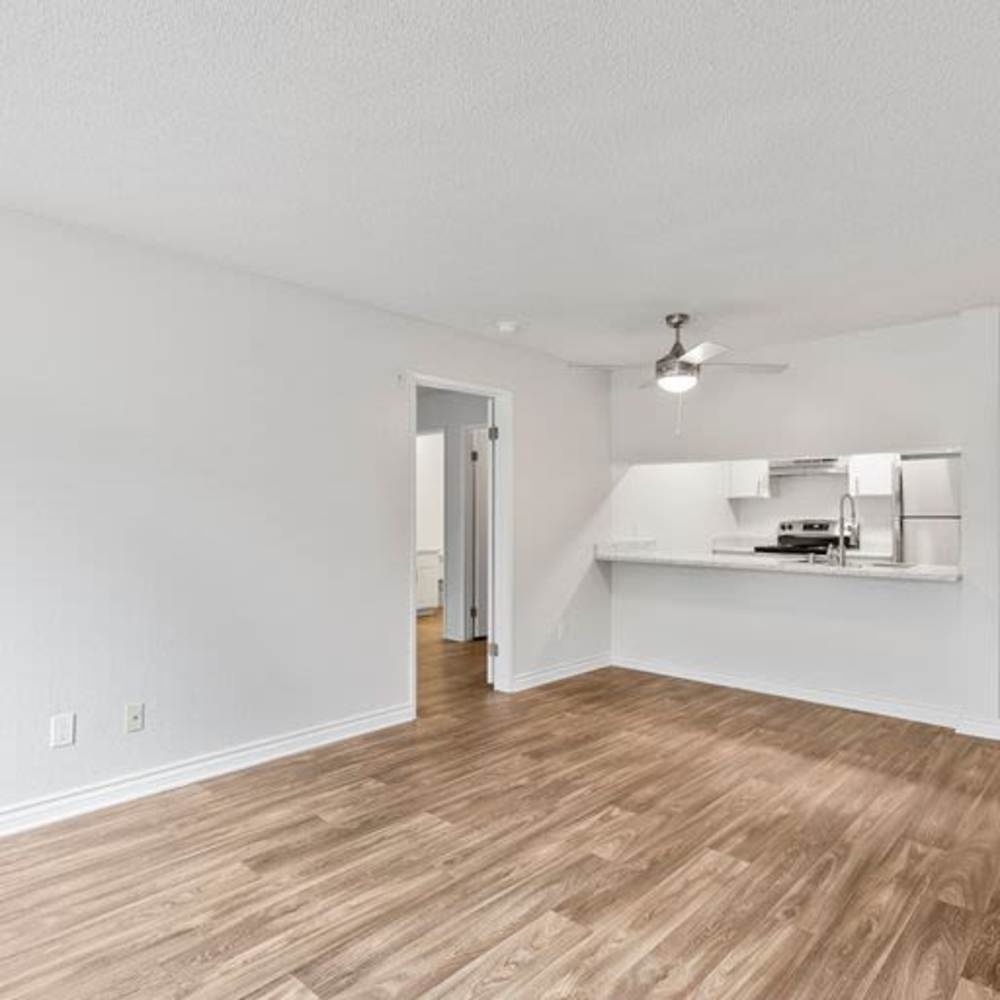 Kitchen and dinning space with wood-style flooring at Mar at Mesa in San Diego, California