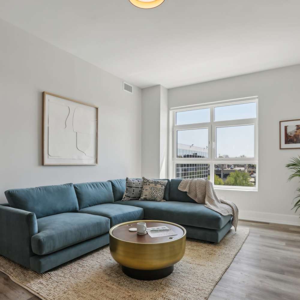 Living room with nice blue sofa at The Magellan in Port Chester, New York