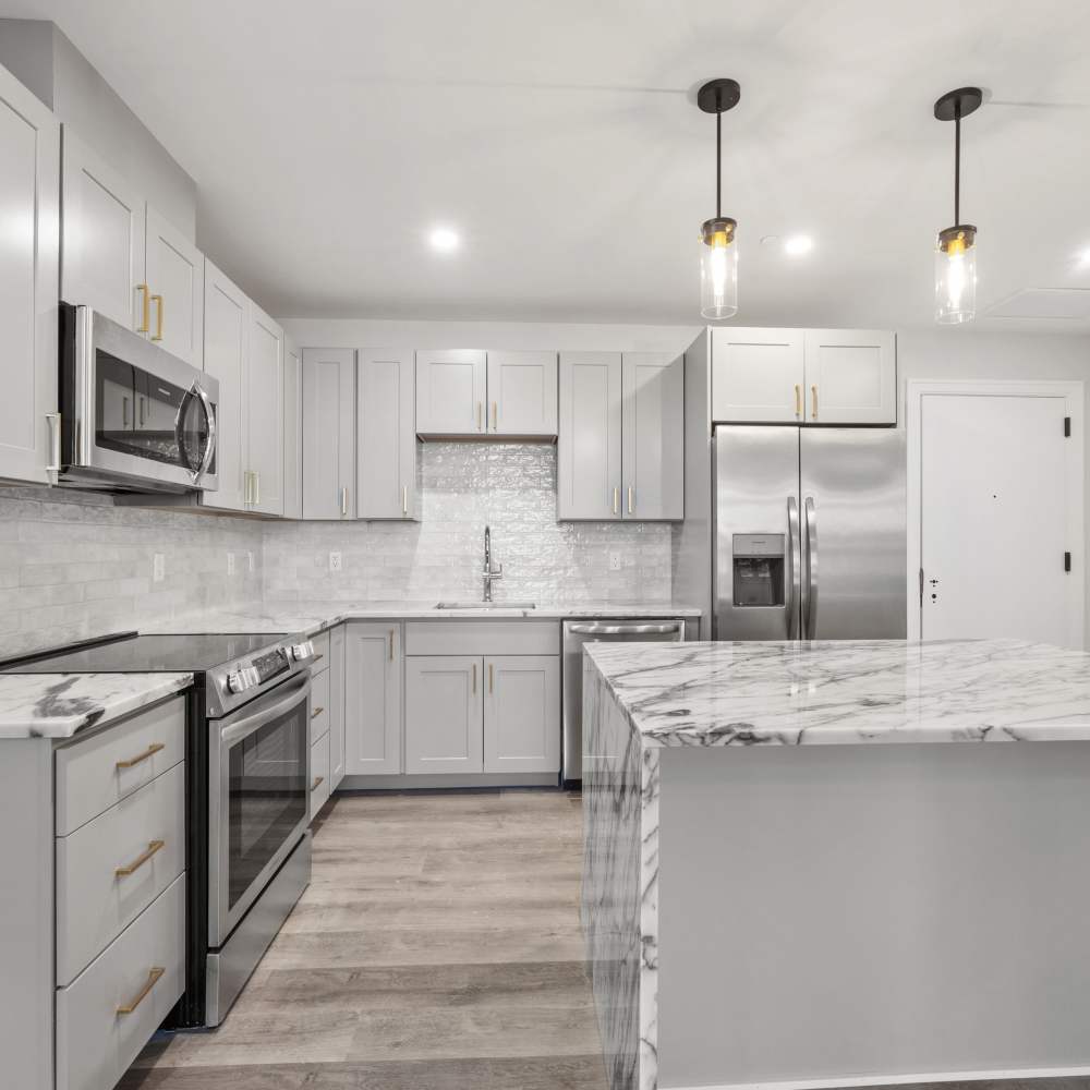 Kitchen with modern marble countertops and island at The Magellan in Port Chester, New York