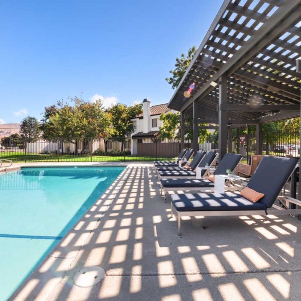Outdoor seating next to pool Mariposa Fremont in Fremont, California