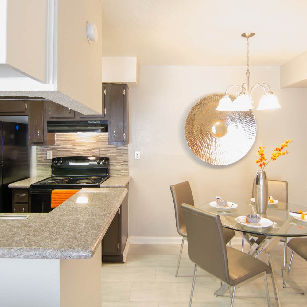 Dining area with bright lighting and open kitchen atVilla Barcelona in Houston, Texas