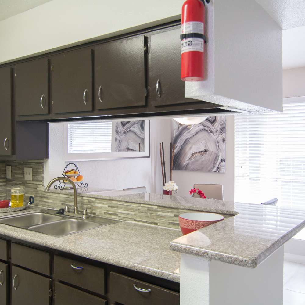 Kitchen with breakfast counter and attached dining area at Villa Barcelona in Houston, Texas