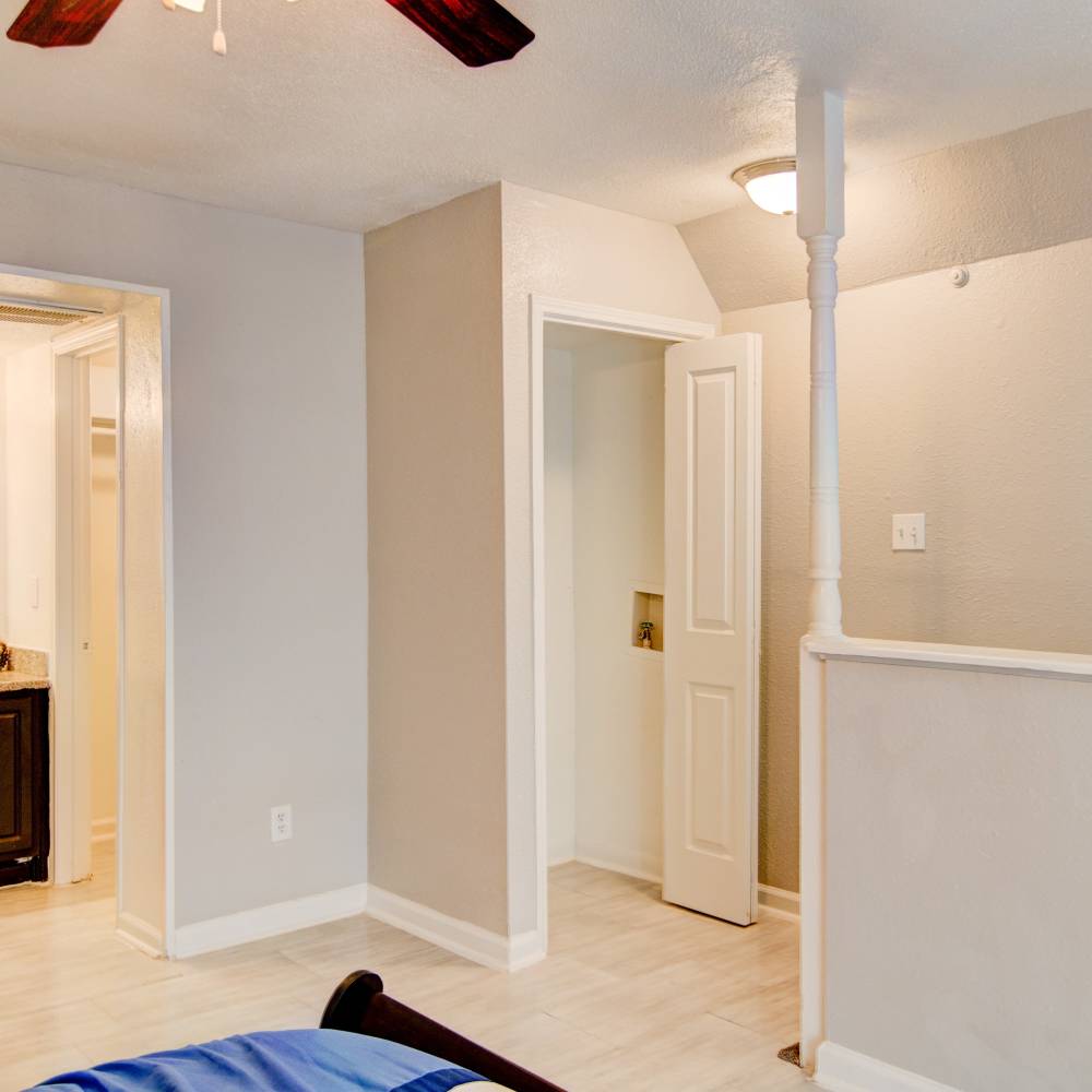 Bedroom with bright lighting and a attached bathroom at Villa Barcelona in Houston, Texas