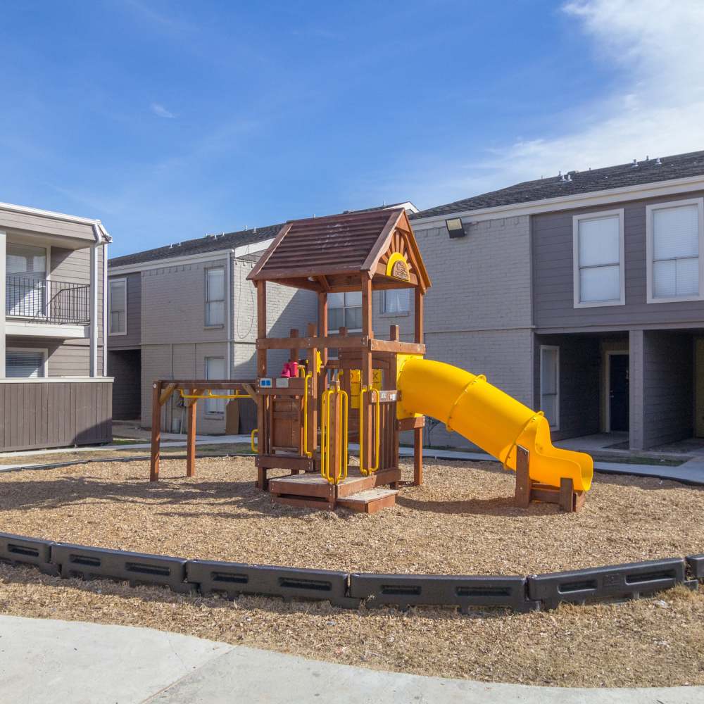  Play area with a slide surrounded by the buildings at Villa Barcelona in Houston, Texas