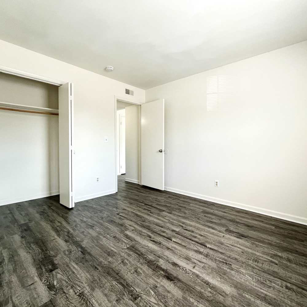 Bedroom with wood-style flooring at Collinwood Apartments in Newport News, Virginia