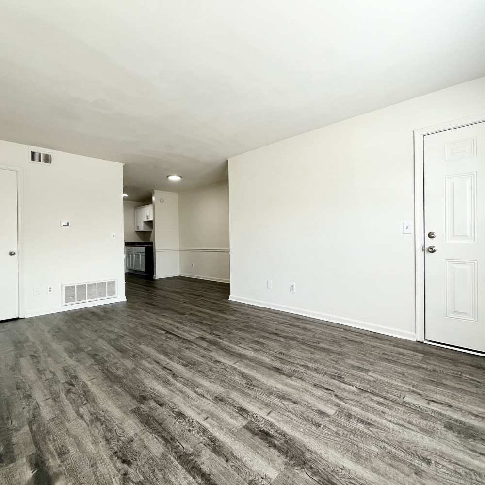 Living space with wood-style flooring at Collinwood Apartments in Newport News, Virginia