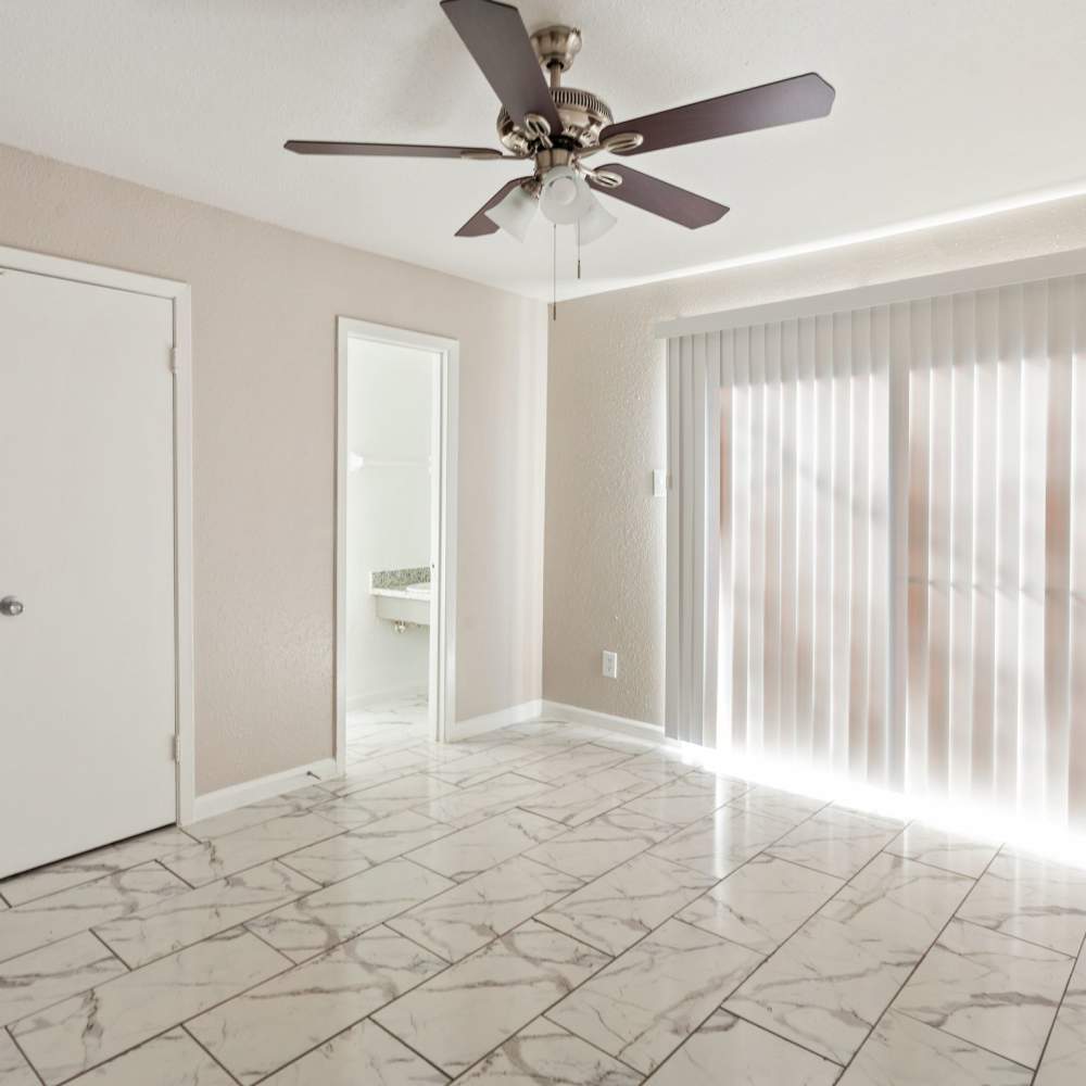 Bedroom space with access to a private patio at La Carmona in Houston, Texas