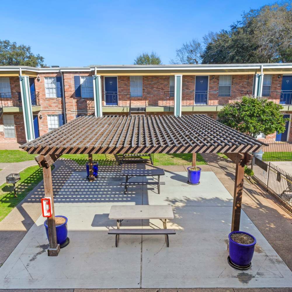 Covered patio area with picnic tables at La Carmona in Houston, Texas