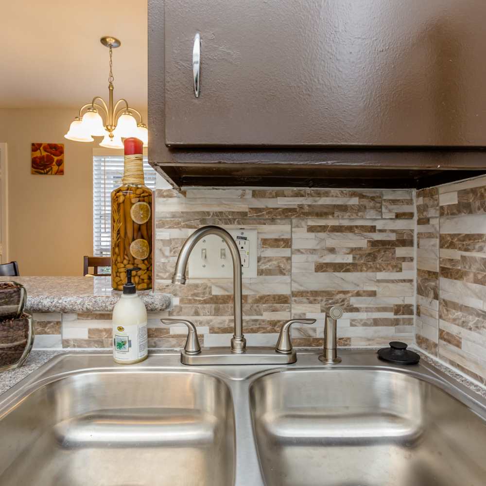 Kitchen with updated faucets at La Carmona in Houston, Texas