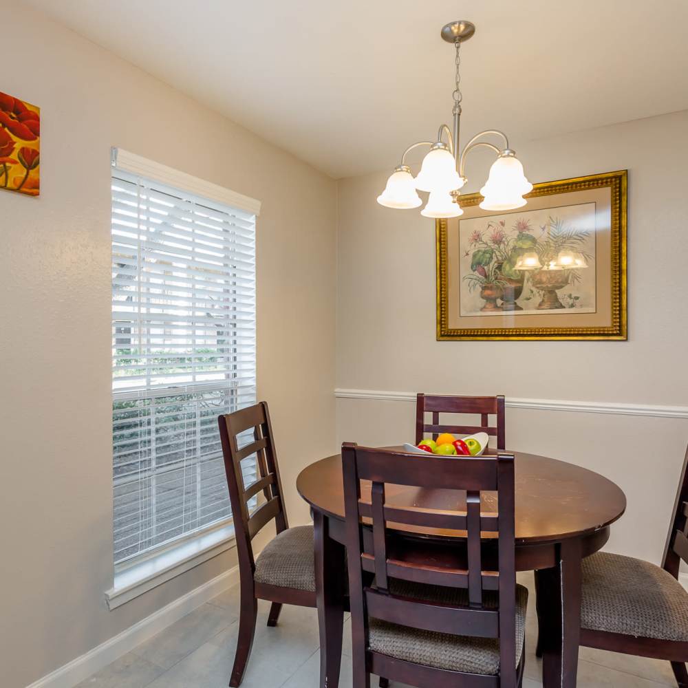 Dinning space with a large window at La Carmona in Houston, Texas