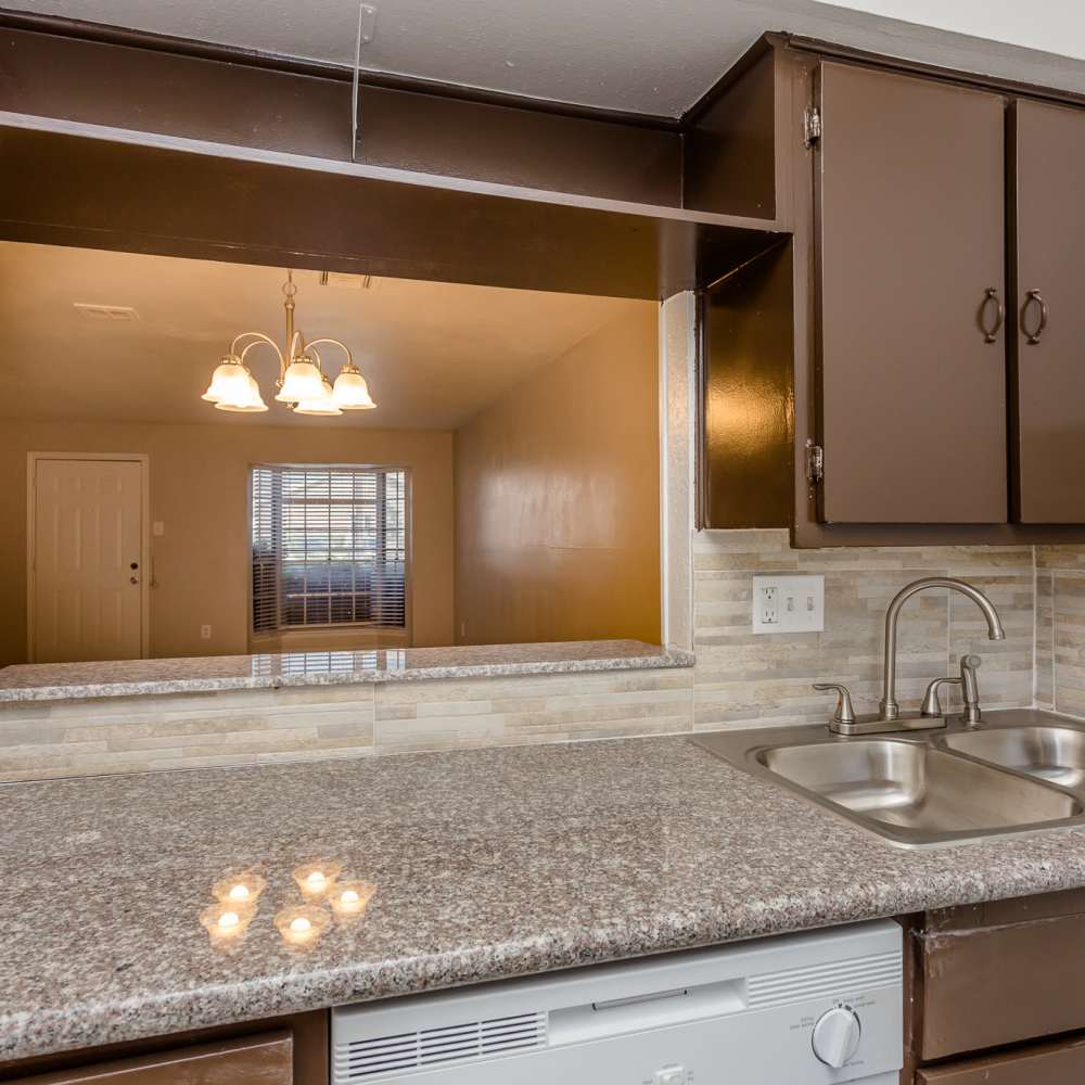 Kitchen with brown cabinets at La Carmona in Houston, Texas