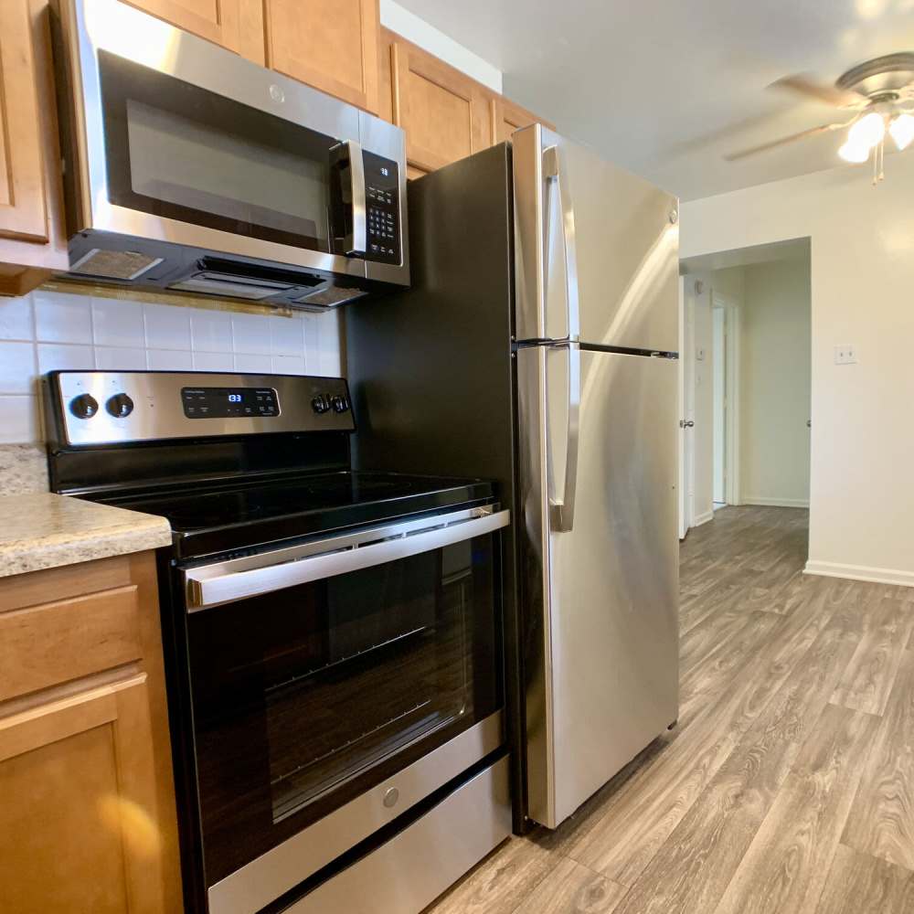 Kitchen and dinning space with wood-style flooring at Great Bridge Apartments in Chesapeake, Virginia