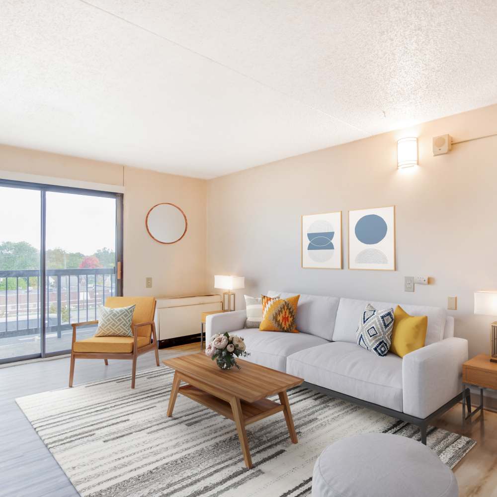 Model living room with a sliding glass door leading to private balcony at Bowin Place in Detroit, Michigan