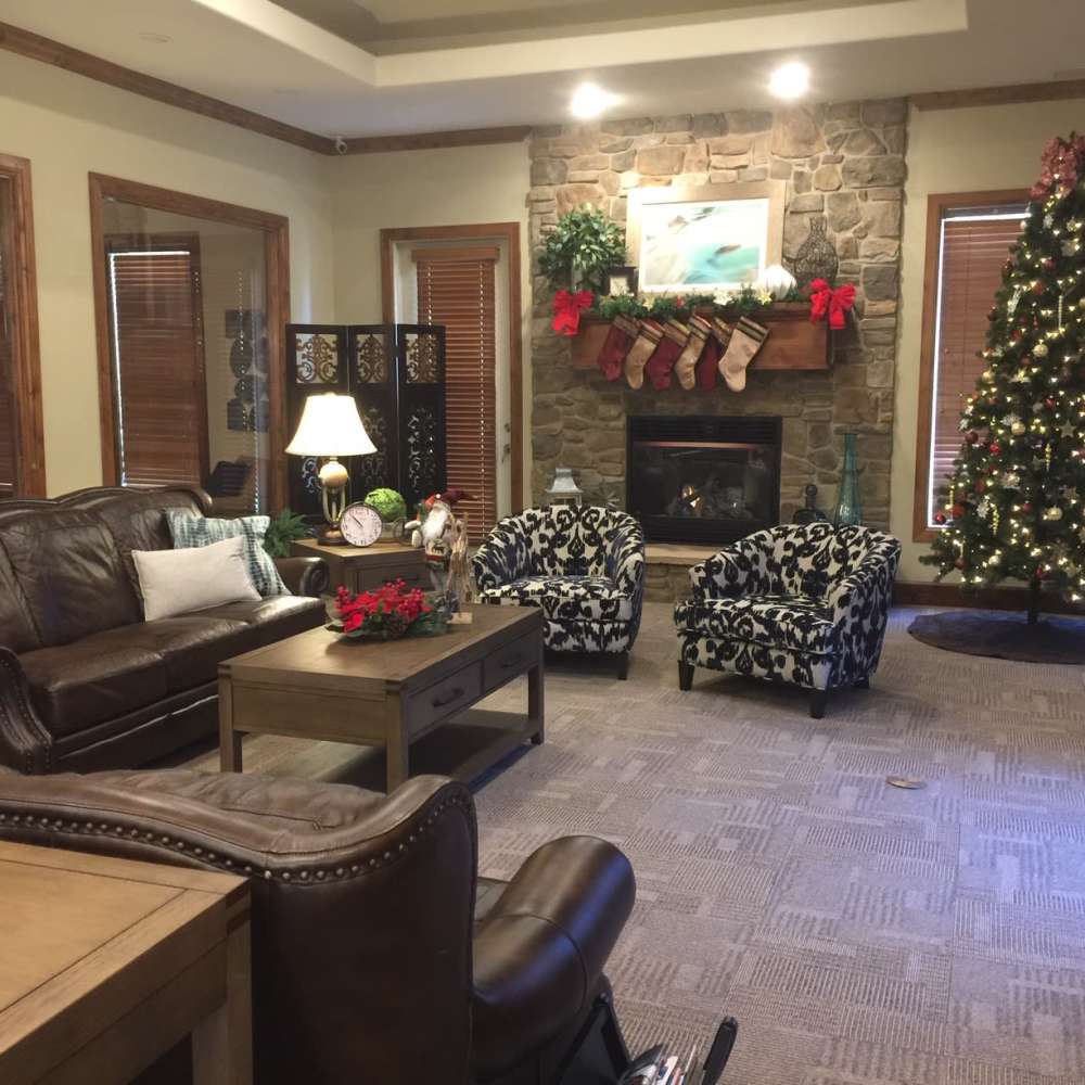 Clubhouse with cozy seating by the fireplace at The Falls at Canyon Rim in South Ogden, Utah