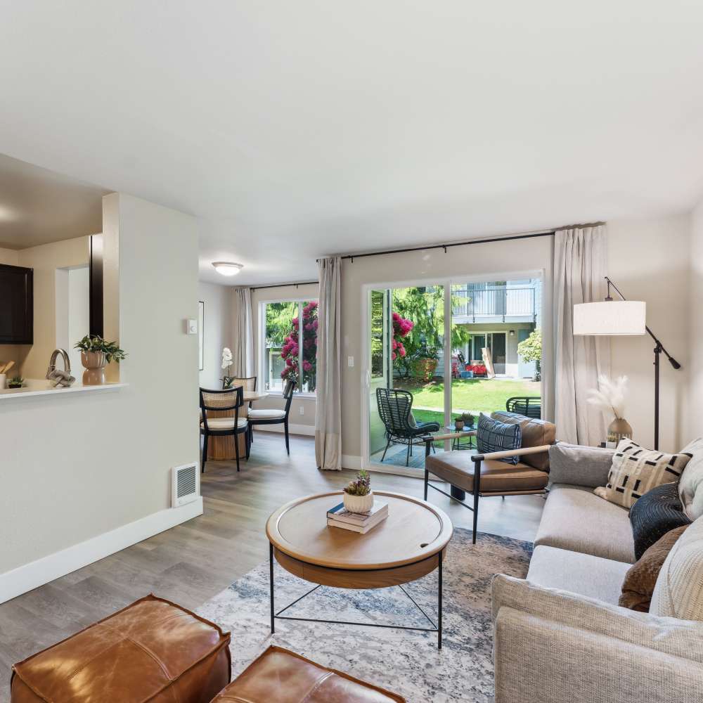 Spacious and modern open-concept floor plan with hardwood-style flooring in a model home at Madison Sammamish Apartments in Sammamish, Washington