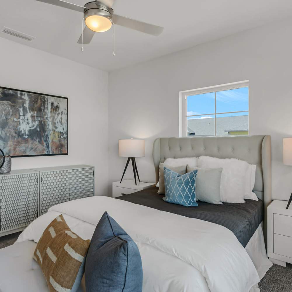 Bedroom with a ceiling fan at Grand Oak Apartments in Largo, Florida
