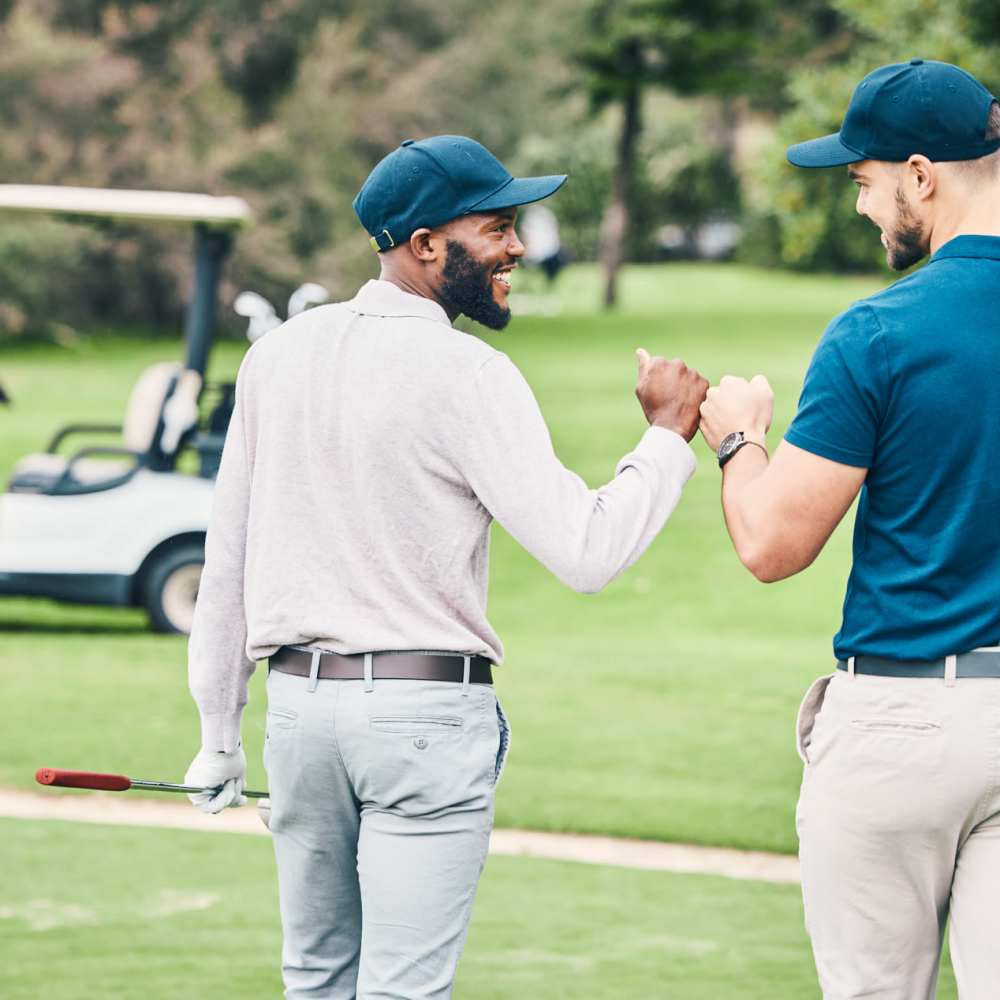 Residents engaged in conversation while playing golf near Fairways Villas II Apartments in Victor, New York