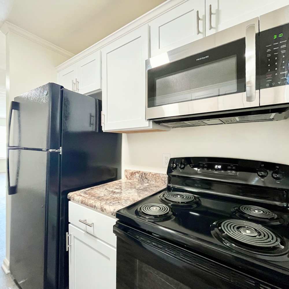 Kitchen with black appliances at Collinwood Apartments in Newport News, Virginia