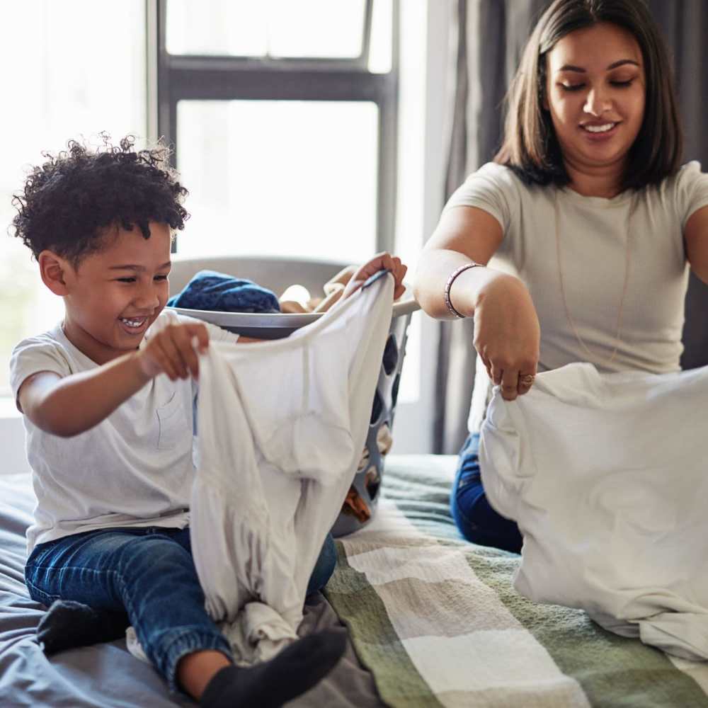 Mother doing laundry with her son at Lake House in Los Angeles, California