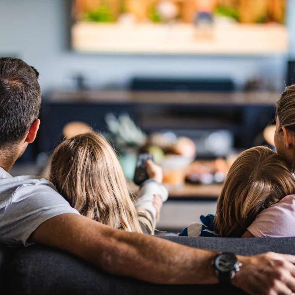 Family seating on comfortable couch at Lake House in Los Angeles, California