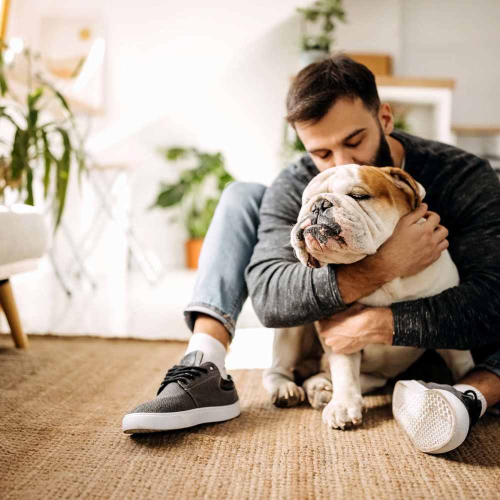 Resident snuggling his dog at À L'aise Hyde Park in Cincinnati, Ohio