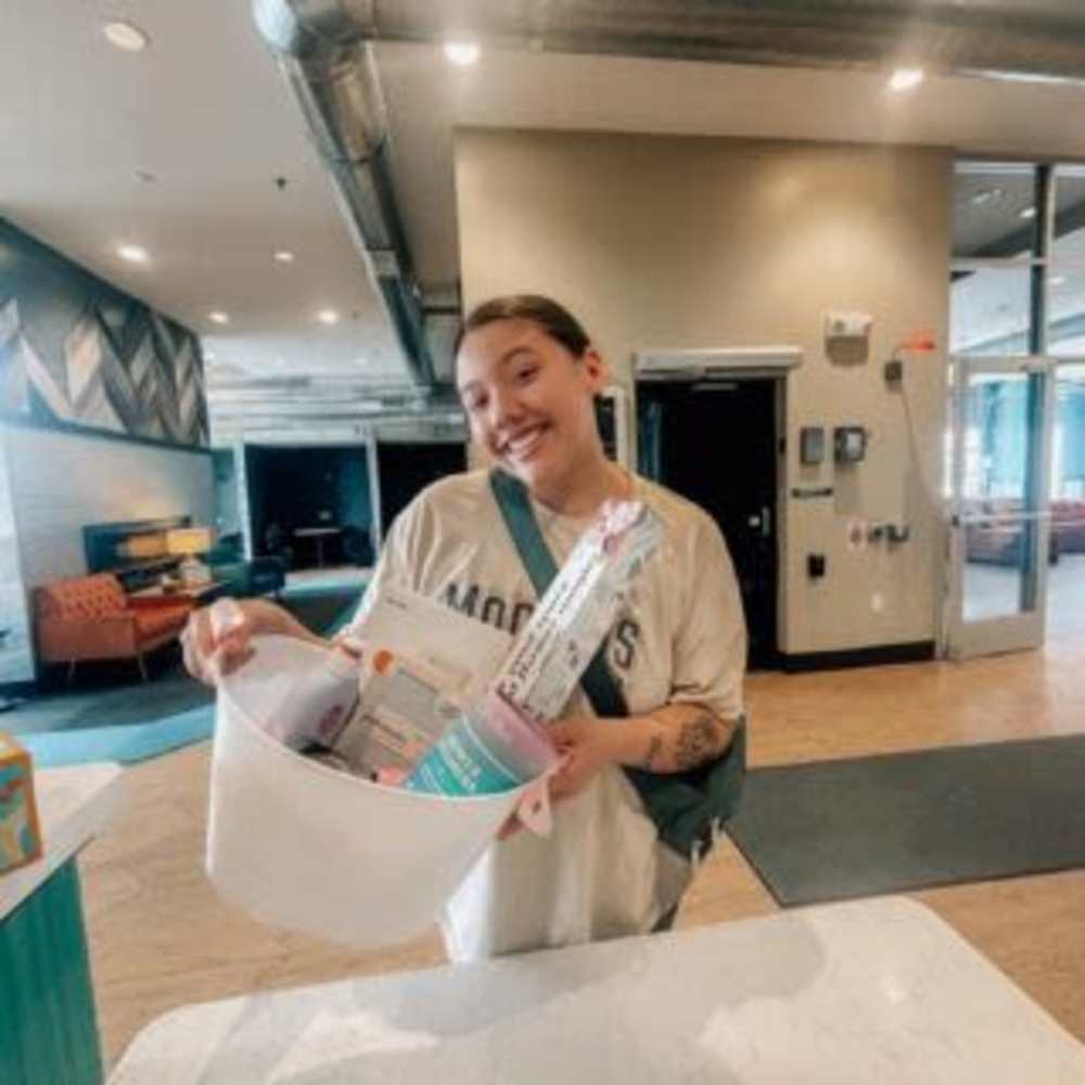 Resident with a giveaway basket at Lofts @ 1633 in Mankato, Minnesota