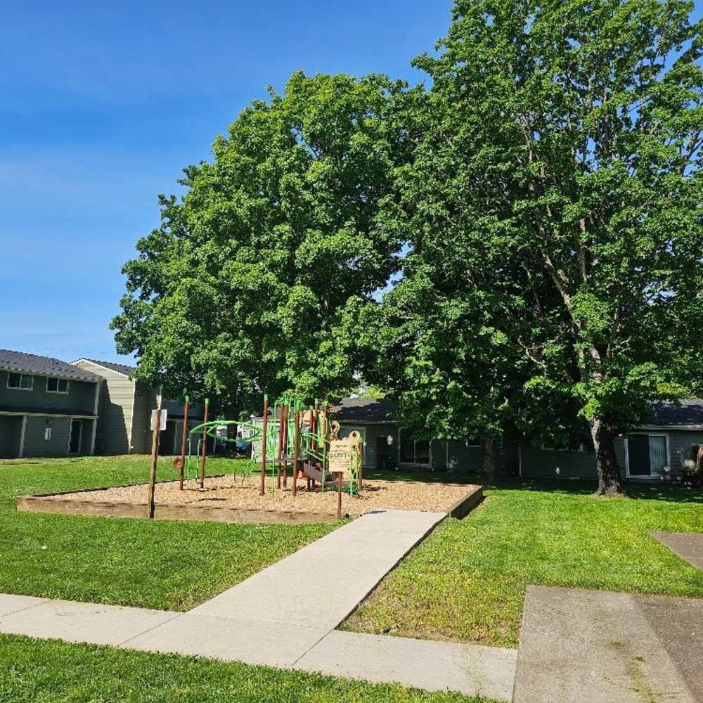 A community playground nestled in a green park at Park Manor in Lebanon, Oregon