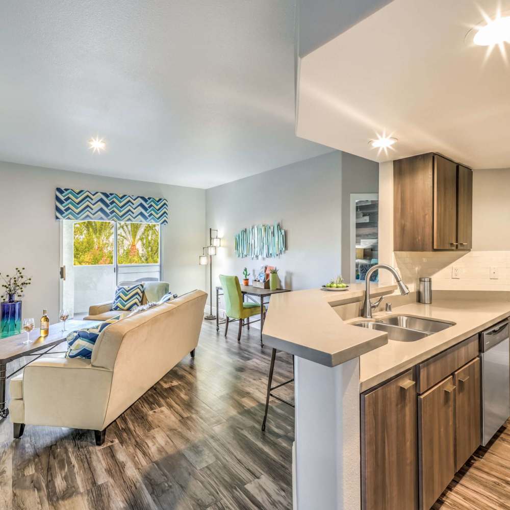 Kitchen and living space with wood-style flooring at Parkway Townhomes in Henderson, Nevada