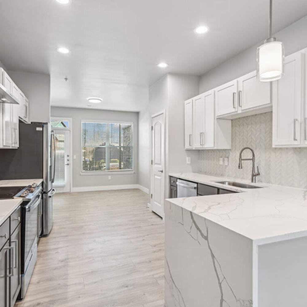 Dining and living area of an apartment home at The Apartments at Brayden in Fort Mill, South Carolina