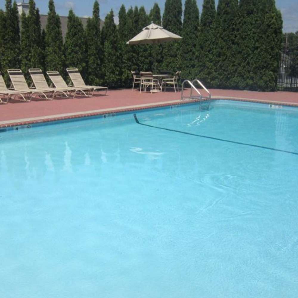 Community pool with lounge chairs at The Regency Club in Middletown, New York